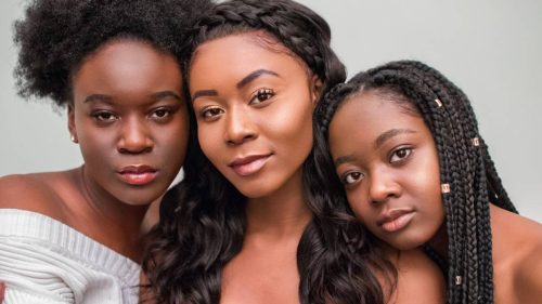 Three black women with different hair - afro, straight and braids.