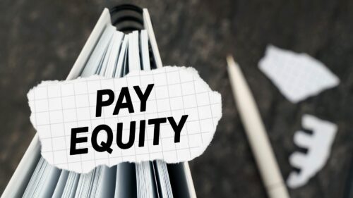 The words pay equity in black type on a piece of paper